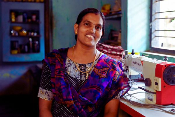 Boy holding a goat with his hands